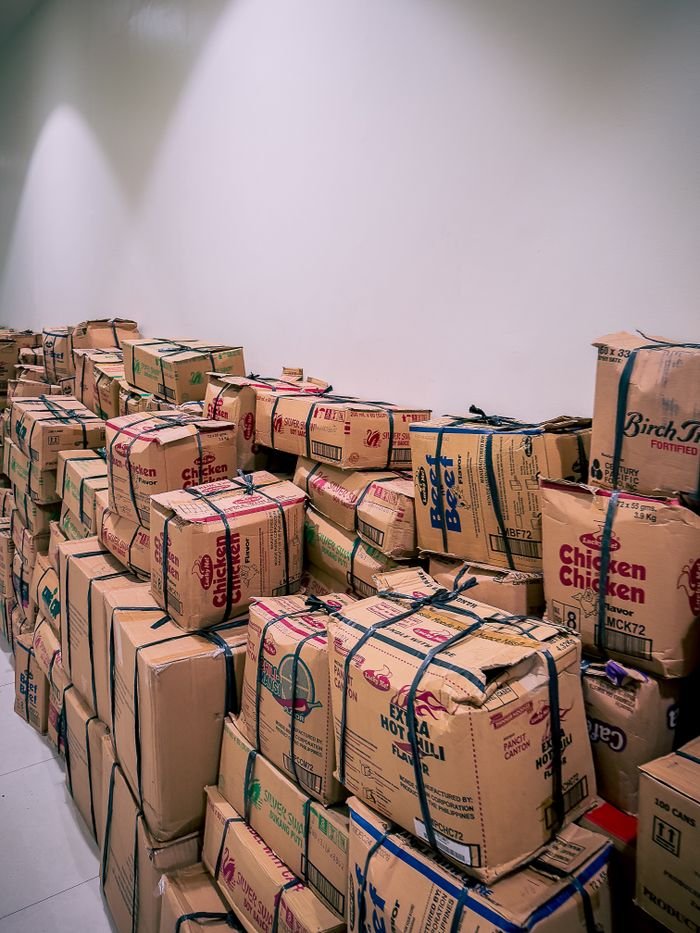 Crafting Captivating Headlines: Your awesome post title goes here Large stack of cardboard boxes in a warehouse setting in Central Visayas, Philippines.