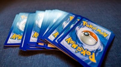 A collection of Pokemon trading cards arranged on a blue couch, ideal for collectors and fans.